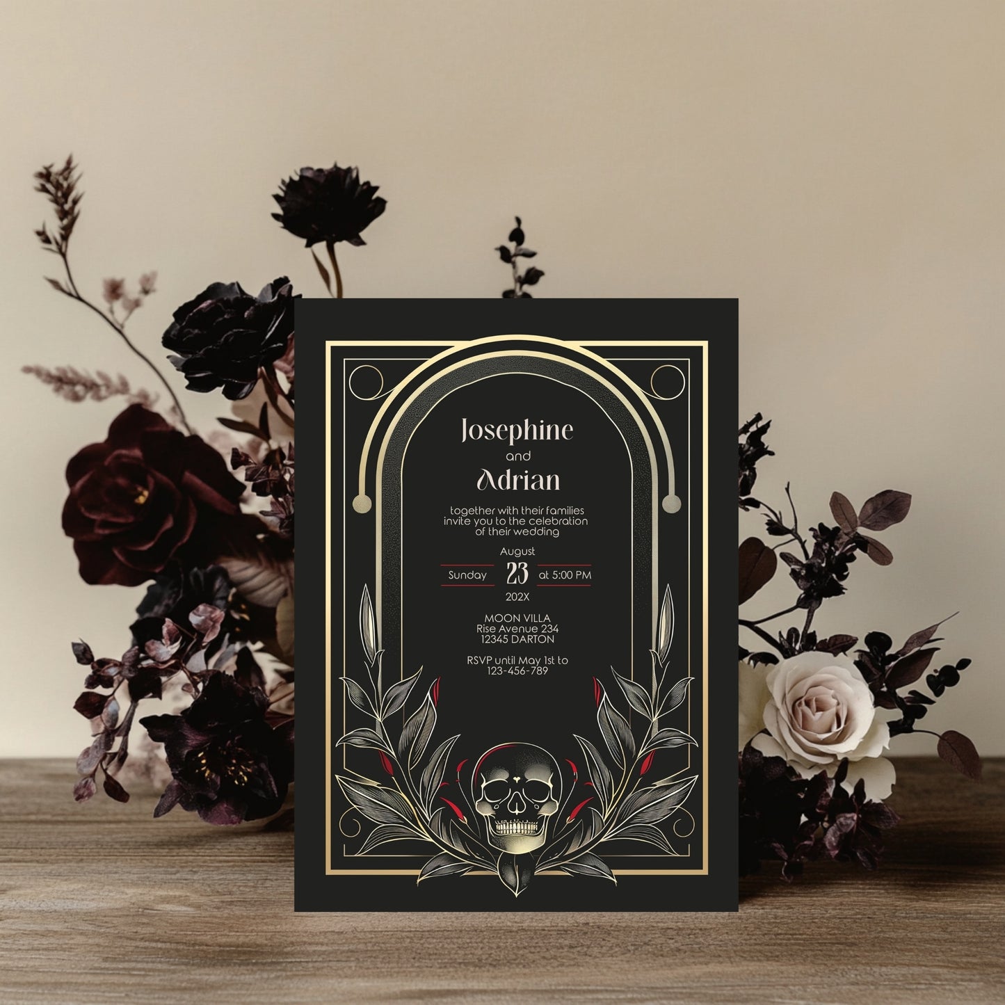 Wedding invitation card with skull design and floral arrangement on a wooden surface