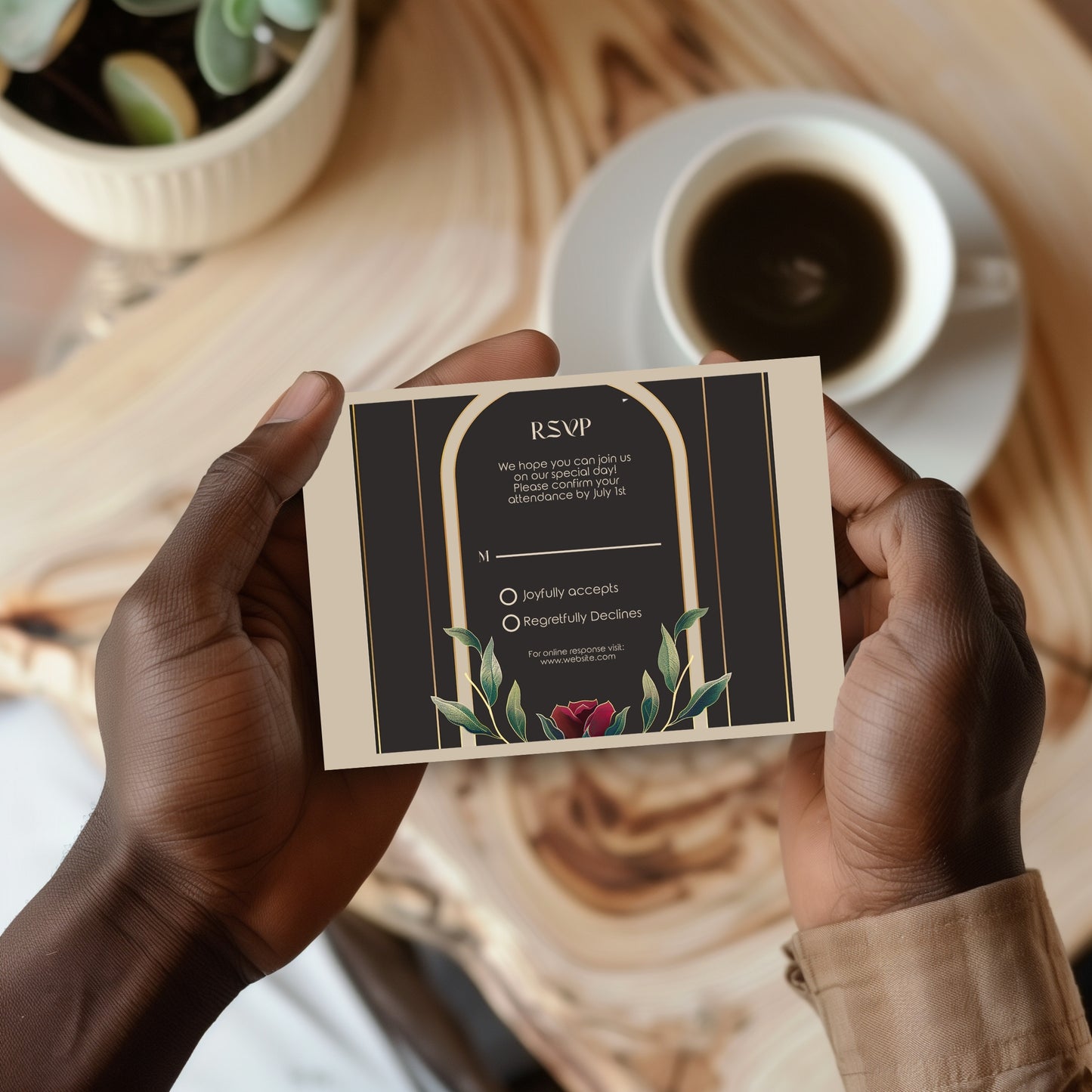 Person holding a vintage styled RSVP card with a cup of coffee and plant in the background